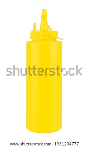 Yellow plastic bottle with dispenser for mustard sauce isolated on white background