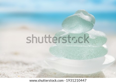 sea glass marbles  with white sand beach  seascape Royalty-Free Stock Photo #1931210447
