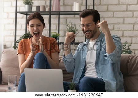 Unbelievable success. Overjoyed young husband wife scream yes super as lucky winners by laptop pc get mortgage loan approval in bank email. Emotional spouses celebrate great victory at betting lottery Royalty-Free Stock Photo #1931220647