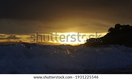 sunset light reflections on the sea wave splash