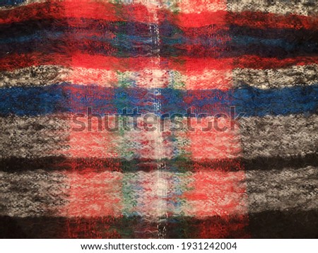 Woolen scarf. Flat lay macro photograph with colorful texture of mohair. Close-up studio photo of wool. Natural material background.
