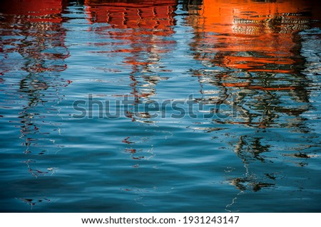 Reflection of fishing boats in the water