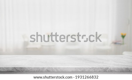 Empty white marble stone table top and blur glass window interior cafe and restaurant banner mock up abstract background - can used for display or montage your products. Royalty-Free Stock Photo #1931266832