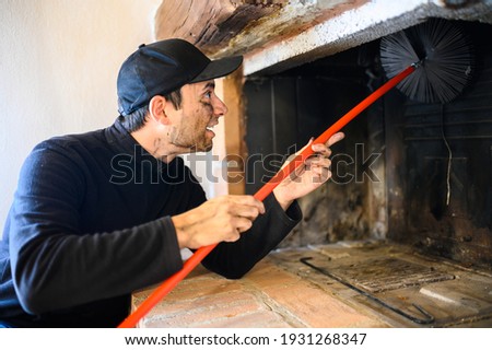 Young chimney sweep at work Royalty-Free Stock Photo #1931268347