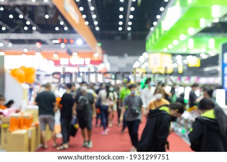 Abstract blur people in exhibition hall event trade show expo background. Business convention show, job fair, or stock market. Royalty-Free Stock Photo #1931299751