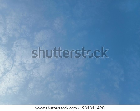Beautiful white clouds on blue sky background. Nature photography. Elegant blue sky picture in sunlight. Big or tiny and soft clouds on blue sky background. Wallpaper background