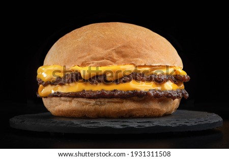 smash burger hamburger cheeseburger hamburgerin dark background Royalty-Free Stock Photo #1931311508