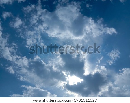 Beautiful white clouds with sunshine on blue sky background. Nature photography. Elegant blue sky picture in sunlight. Big or tiny and soft clouds on blue sky background. Wallpaper background