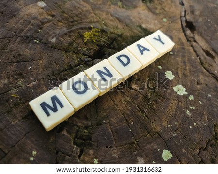 Selective focus.Scrabble letters with text MONDAY wooden background.