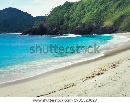 Semeti beach with its beauty in the form of white sand, blue sea and kryptonite rocks, a hidden beach in Lombok, Indonesia Royalty-Free Stock Photo #1931323829