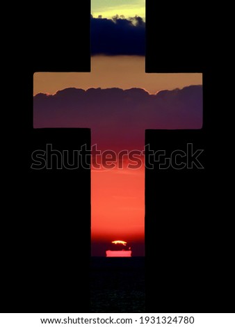 a sunrise seen through a cross