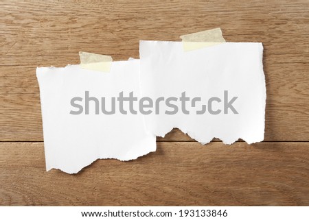 Ripped white paper on wood background