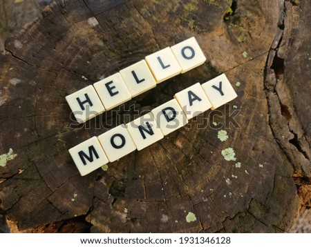 Selective focus.Scrabble letters with text HELLO MONDAY wooden background.