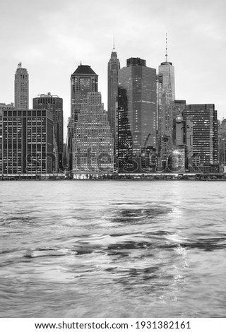 Black and white picture of New York City waterfront at sunset, USA.