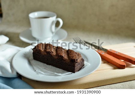 chocolate brownies dessert on white plate and a cup of tea