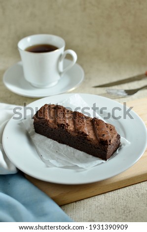 chocolate brownies dessert on white plate and a cup of tea