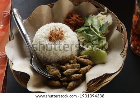 Sego wader. Sego wader is traditional food from Indonesia which consist of deep fried little river fish served with cucumber,  vegetables and hot traditional sauce.