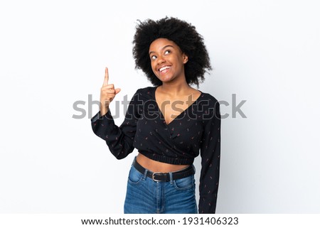 Young African American woman isolated on white background pointing up and surprised