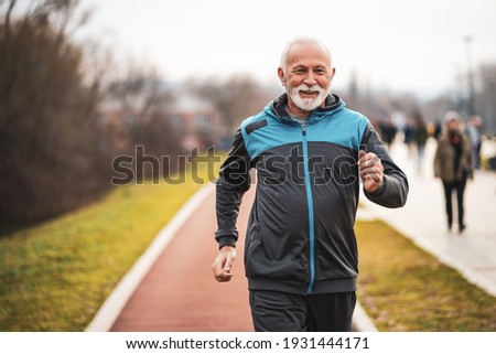 Active senior man is jogging. Healthy retirement lifestyle. Royalty-Free Stock Photo #1931444171