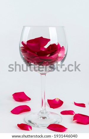 Red rose leaves in a glass