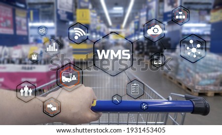 Inscription WMS on blurred warehouse background. Werehouse Management System Royalty-Free Stock Photo #1931453405