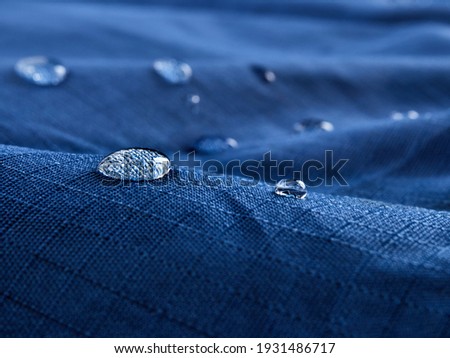 Water drops on blue fabric.