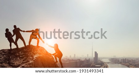 Teamwork concept. People who help their peers. Human relationship. Royalty-Free Stock Photo #1931493341