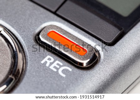 Red REC recording button on a modern pocket audio voice recorder, switch object macro extreme closeup Secretly recording, journalist or reporter equipment, simple live music recording abstract concept Royalty-Free Stock Photo #1931514917