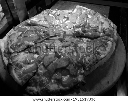 Delicious pizza on a table in a restaurant in Black and White color