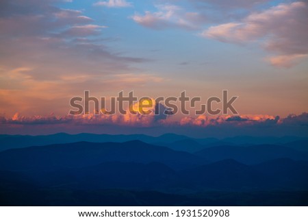 Gorgeous sunset with cloudy sky in the mountains. Photo of textured sky. Scenic image of dramatic light in summer weather. Breathtaking natural wallpaper background. Discover the beauty of earth.
