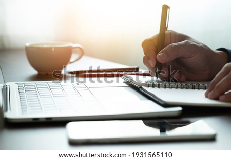 man hand using writing pen memo on notebook paper or letter, diary on table desk office. Workplace for student, writer with copy space. business working and learning education concept. Royalty-Free Stock Photo #1931565110