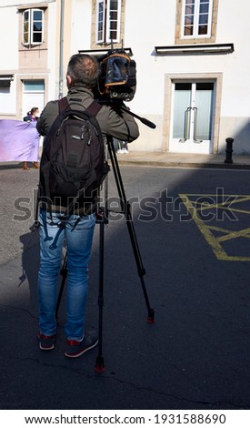 Television camera operator at a street event