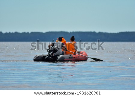 tourists swim on the river by boat