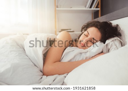 Feeling calmness. Sleepy female keeping eyes closed while dreaming about future vacation or sleeping at the bedroom. Stock photo Royalty-Free Stock Photo #1931621858