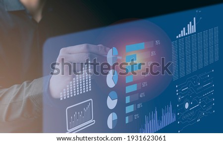 A young businessman pointing at a graph, Concept image of data gathering and statistical working. Optimize business process workflow.