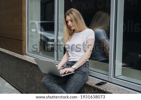 Earn extra money, Side hustle, money making, turning hobbies into cash, Gig economy, digital nomad. Young woman, student with laptop and smartphone working outside.