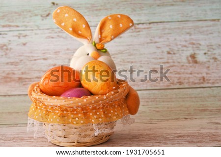 bunny with Easter eggs in a basket 