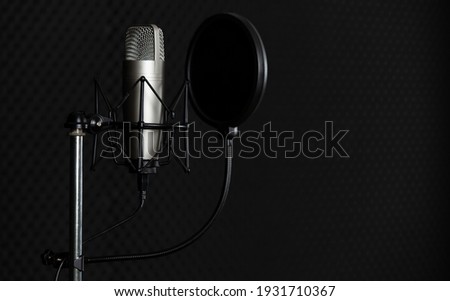 Set of condencer microphone with pop up filter in dark voice recording studio