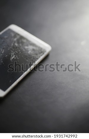 Crack on the glass. Broken screen. Broken phone. Cracked glass background. White cracks in glass.