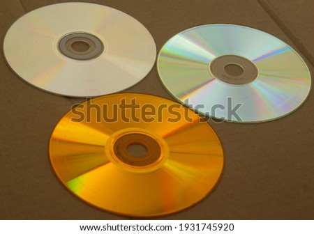 Some CDs together on a cardboard base