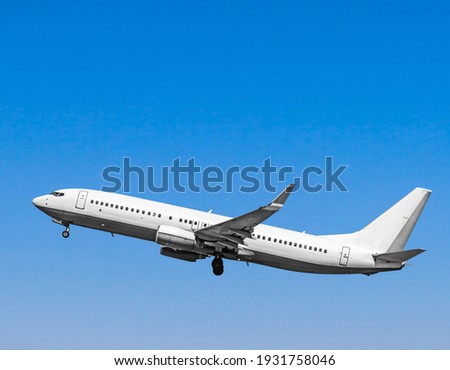 Plane at takeoff, the plane in the blue sky Royalty-Free Stock Photo #1931758046