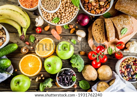 Healthy food. Selection of good carbohydrate sources, high fiber rich food. Low glycemic index diet. Fresh vegetables, fruits, cereals, legumes, nuts, greens. Wooden background copy space Royalty-Free Stock Photo #1931762240