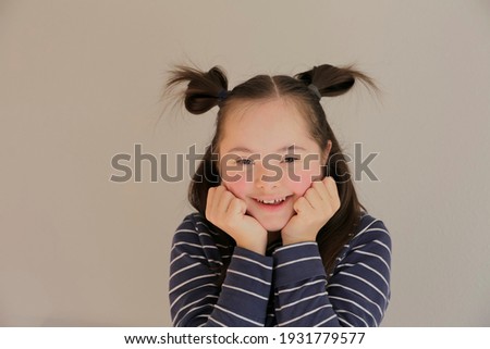 Cute smiling girl isolated on the grey background