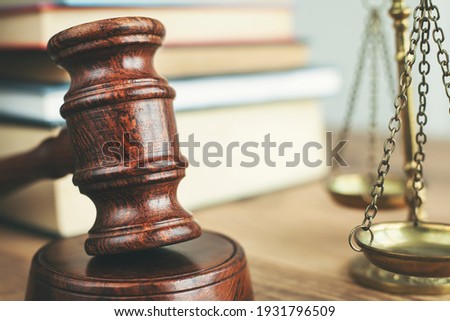 Justice legal and jurisprudence concept. Law books on lawyer desk at law firm.