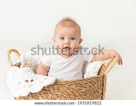 7 month old baby boy sitting in white neutral studio