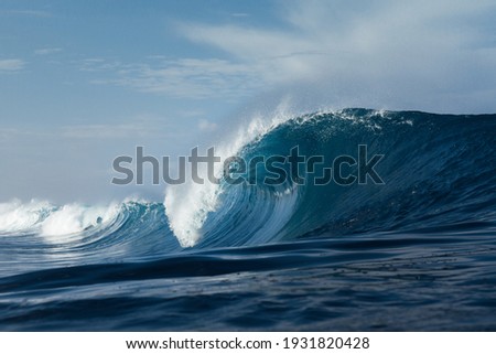 Blue wave breaking on a beach in sea Royalty-Free Stock Photo #1931820428