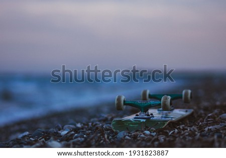 Skateboard background on the beach next to the sea 