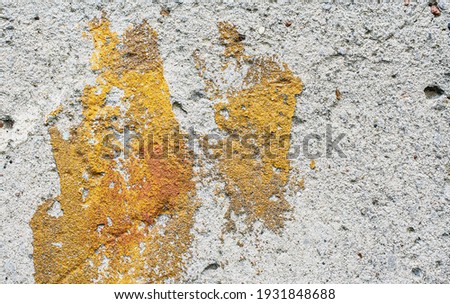 Grungy wall background with cracks, stones and paint. 