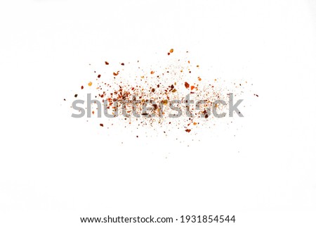 Red Hot Cayenne pepper isolated. Pile crushed red cayenne pepper, dried chili flakes and seeds isolated on white background Royalty-Free Stock Photo #1931854544