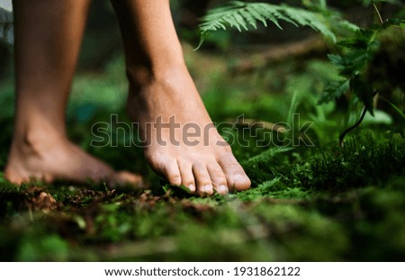 Bare feet of woman standing barefoot outdoors in nature, grounding concept. Royalty-Free Stock Photo #1931862122